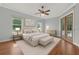 Serene bedroom featuring two windows, neutral decor, wood floors, and a comfortable layout at 19232 Somerset St, Orlando, FL 32833