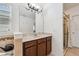 Well-lit bathroom featuring a spacious vanity, large mirror, and tiled accents, blending functionality and style at 1961 Continental St, St Cloud, FL 34769