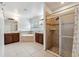 Elegant bathroom with dual vanities, soaking tub, walk-in shower, and tiled floors, offering a spa-like experience at 1961 Continental St, St Cloud, FL 34769