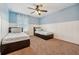 Bedroom with a fan, two beds, carpet floors and blue painted walls at 1961 Continental St, St Cloud, FL 34769