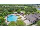Aerial view of community pool, playground, and clubhouse with lush landscaping and ample seating at 1961 Continental St, St Cloud, FL 34769