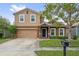 Charming two-story home with a well-maintained lawn, a two car garage, and beautiful landscaping at 1961 Continental St, St Cloud, FL 34769