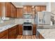 Kitchen with stainless steel appliances, sleek granite countertops, modern cabinets, and wood flooring at 1961 Continental St, St Cloud, FL 34769