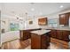 Modern kitchen with a center island, granite countertops, stainless steel appliances, and wood flooring at 1961 Continental St, St Cloud, FL 34769