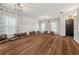 Sunlit living room with sleek hardwood floors, large windows, modern lighting, and contemporary decor at 1961 Continental St, St Cloud, FL 34769