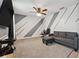 Cozy living room with geometric wall design, modern furniture, and plush carpet, ideal for relaxation and entertainment at 1961 Continental St, St Cloud, FL 34769
