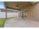 Covered back patio with ceiling fan and view of fenced backyard at 1961 Continental St, St Cloud, FL 34769