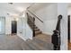Inviting staircase with carpeted steps and elegant black railings, blending style and functionality for easy access at 1961 Continental St, St Cloud, FL 34769