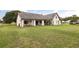 Spacious backyard with a well-maintained lawn, offering ample space for outdoor activities at 2050 Jan Lan Blvd, St Cloud, FL 34772