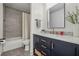 Nicely decorated bathroom with a shower and tub, a vanity with gold faucet, and a gray tiled floor at 2050 Jan Lan Blvd, St Cloud, FL 34772