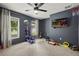 Spacious bedroom with gray walls, large windows, and a wall-mounted TV for entertainment at 2050 Jan Lan Blvd, St Cloud, FL 34772
