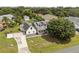Aerial shot highlighting the home with a long driveway, a large lawn, and solar panels at 2050 Jan Lan Blvd, St Cloud, FL 34772
