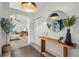 Stylish foyer with modern lighting, elegant decor, and a glimpse of the living room at 2050 Jan Lan Blvd, St Cloud, FL 34772
