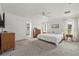 Bright main bedroom with light gray carpet, white walls, and ensuite bath with glass shower at 2050 Jan Lan Blvd, St Cloud, FL 34772