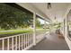 Inviting covered porch with rocking chairs, perfect for enjoying the peaceful neighborhood views at 2050 Jan Lan Blvd, St Cloud, FL 34772