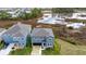 Up-close aerial view of gray two-story home with a pond in the background at 2222 Derwent Dr, Davenport, FL 33896
