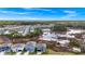 Aerial view of houses near a pond with blue skies and scattered clouds at 2222 Derwent Dr, Davenport, FL 33896