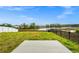 Grassy backyard area overlooking a retention pond with a concrete slab in foreground and perimeter fences at 2222 Derwent Dr, Davenport, FL 33896