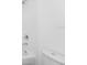 Bathroom with a bathtub-shower combo and white tile at 2222 Derwent Dr, Davenport, FL 33896