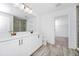 Bright bathroom featuring a double sink vanity, wood-look tile floor, and glass-enclosed shower at 2222 Derwent Dr, Davenport, FL 33896