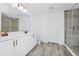 Elegant bathroom with double vanity, stone counters, decorative lighting, and a glass-enclosed shower at 2222 Derwent Dr, Davenport, FL 33896