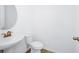 A bathroom featuring a pedestal sink, toilet and light wood-look flooring at 2222 Derwent Dr, Davenport, FL 33896
