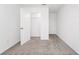 Bedroom with neutral carpet flooring, a white door and a closet with white wire shelving at 2222 Derwent Dr, Davenport, FL 33896