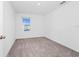 This bedroom boasts light-filled space with neutral carpet and a window with a view at 2222 Derwent Dr, Davenport, FL 33896