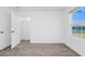 Neutral bedroom with a window letting in natural light and an open door to a walk-in closet at 2222 Derwent Dr, Davenport, FL 33896