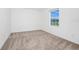 Bright bedroom with a window letting in natural light and neutral carpeting at 2222 Derwent Dr, Davenport, FL 33896