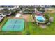 Aerial view of tennis courts and community pool with clubhouse in the background at 2222 Derwent Dr, Davenport, FL 33896
