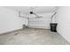 Spacious two-car garage interior featuring a finished concrete floor and an automatic door at 2222 Derwent Dr, Davenport, FL 33896