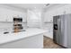 Open kitchen with stainless steel appliances, pantry, white cabinets, and an island at 2222 Derwent Dr, Davenport, FL 33896