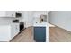 Modern kitchen featuring stainless steel appliances, white cabinets, and a large island at 2222 Derwent Dr, Davenport, FL 33896