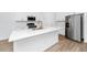 This kitchen features white cabinets, stainless appliances, quartz countertops, and modern gold hardware and faucet at 2222 Derwent Dr, Davenport, FL 33896