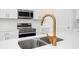 Close up of kitchen island's sink, faucet, and oven at 2222 Derwent Dr, Davenport, FL 33896