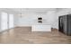 Open concept living and kitchen area featuring stainless appliances and hardwood floors at 2222 Derwent Dr, Davenport, FL 33896