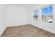 Open-concept living room with wood-look flooring and natural light from a double window at 2222 Derwent Dr, Davenport, FL 33896