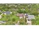 Expansive aerial view of a home with lush landscaping, a private driveway, and neighboring houses surrounded by mature trees at 2342 Audley St, Oviedo, FL 32765