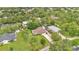 Aerial view of a home surrounded by trees, featuring a well-manicured lawn and a long driveway leading up to the residence at 2342 Audley St, Oviedo, FL 32765