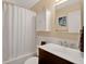 Bathroom with white subway tile, dark cabinets, and a shower-tub combination at 2342 Audley St, Oviedo, FL 32765