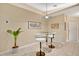 Breakfast nook area features modern bar stools, a glass table, and an artful arrangement of decor at 2342 Audley St, Oviedo, FL 32765