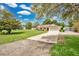 Exterior of home with a lush lawn, driveway leading to a two-car garage, and mature trees at 2342 Audley St, Oviedo, FL 32765