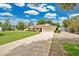 The exterior of this home features a lush lawn, a two-car garage, and mature trees in a charming neighborhood at 2342 Audley St, Oviedo, FL 32765
