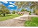 Exterior of home with a lush lawn, driveway leading to a two-car garage, and mature trees at 2342 Audley St, Oviedo, FL 32765