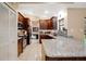 Open kitchen boasts stainless steel appliances, beautiful tile backsplash, and granite countertops at 2342 Audley St, Oviedo, FL 32765