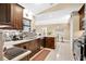 Spacious kitchen features stainless steel appliances, granite countertops, and dark wood cabinetry at 2342 Audley St, Oviedo, FL 32765
