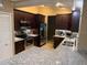 Modern kitchen with stainless steel appliances, granite countertops, and rich wood cabinets, perfect for cooking and entertaining at 2342 Audley St, Oviedo, FL 32765