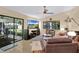 Spacious living room with a sliding glass door to the outdoor patio, ceiling fan, and comfortable furnishings at 2342 Audley St, Oviedo, FL 32765