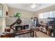 Home office features a large desk, open shelving, and dual windows for natural light at 2342 Audley St, Oviedo, FL 32765